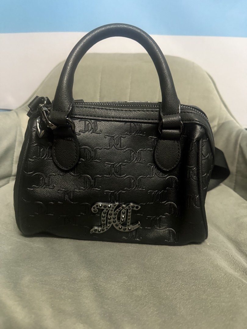 Juicy Couture Black Embossed Monogram Handbag (Category: Luxury Bags & Wallets) located in Quezon City. Submitted by karlalorde (Listing ID 1460043367, Image 1). Description: - Authentic Juicy Couture handbag - All-over embossed JC monogram pattern - Sparkly JC logo on the front - Convenient top handles - Secure zip closure - Adorable charm attached to the handle - Ideal for everyday use.