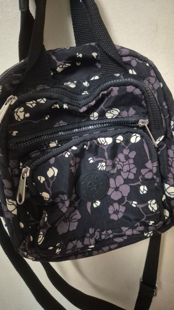 Kipling Black Floral Crossbody Bag (Category: Cross-body Bags) located in Quezon City. Submitted by hamunyi (Listing ID 1460018181, Image 3). Description: - Adorable black crossbody bag with a charming floral print. - Features multiple zippered compartments for excellent organization. - Adjustable strap for comfortable, customized wear. - Ideal for everyday use, keeping your essentials handy. - Comes with a few cute charms already attached. - App
