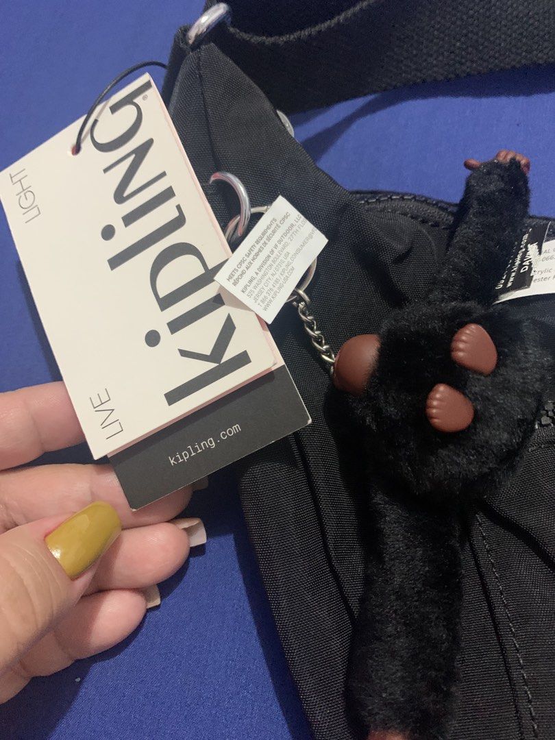 Kipling Black Nylon Sling Bag with Monkey Keychain (Category: Cross-body Bags) located in Malabon City. Submitted by eeroc (Listing ID 1460103714, Image 3). Description: - Authentic Kipling sling bag - Durable nylon material - Features a front zip pocket and an additional smaller zip pocket - Includes the iconic Kipling monkey charm - Adjustable strap for personalized comfort - Ideal for everyday wear and travel.