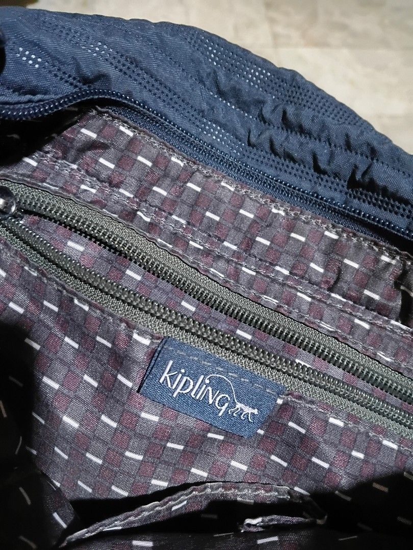 Kipling Dark Blue Quilted Crossbody Bag (Category: Cross-body Bags) located in Cavite. Submitted by ms.de.clutter (Listing ID 1460031723, Image 3). Description: - Authentic Preloved Kipling - purchased from the mall - Dark blue Kipling crossbody bag - Quilted exterior pattern - Cool checkered interior lining - Secure zipper closure - Includes signature Kipling monkey charm - Plenty of space for essentials - Adjustable strap for comfortable wear -