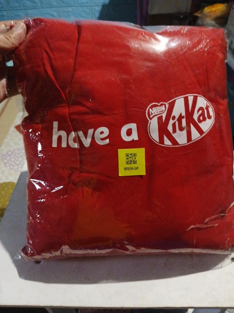 KitKat "Have a break" Red Pillow (Category: Bedding & Towels) located in Manila. Submitted by diczenestr94951 (Listing ID 1460010817, Image 3). Description: - Brand new red pillow with 'Have a break' text and KitKat logo. - Still in original packaging. - Ideal for KitKat enthusiasts or as a cozy sofa accent. - Measures approximately [insert size here if known]..