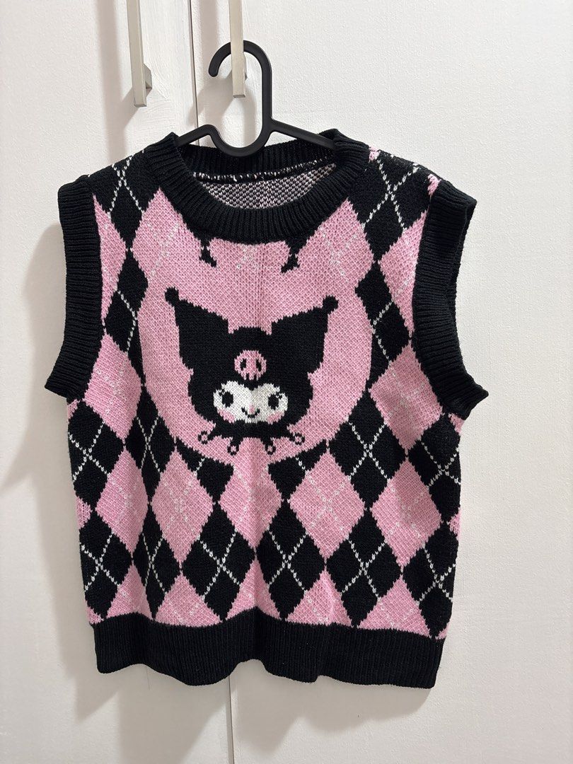 Kuromi Argyle Knit Sweater Vest Pink Black (Category: Sleeveless) located in Caloocan City. Submitted by preloved_tiffanyycollects (Listing ID 1460104607, Image 1). Description: - Adorable Kuromi argyle knit sweater vest - Features a pink and black diamond pattern - Central Kuromi graphic for a kawaii touch - Sleeveless design with comfortable ribbed trim - Ideal for layering over shirts or dresses - Adds a fun, stylish element to any outfit.