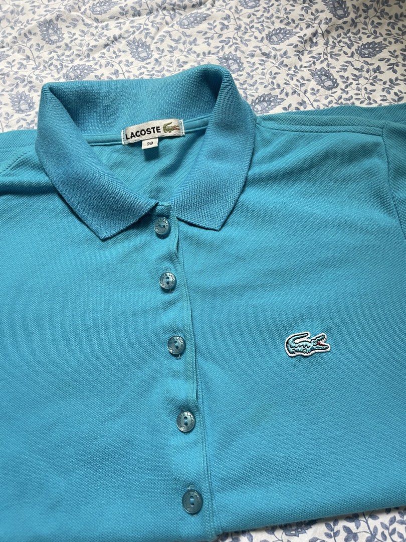Lacoste Blue Polo Shirt Size 38 (Category: Shirts) located in General Trias. Submitted by lyzcollections. (Listing ID 1459905865, Image 3). Description: - Classic blue Lacoste polo shirt - Iconic crocodile logo on chest - Button-up neckline - Size 38 - Ideal for casual or sporty outfits.