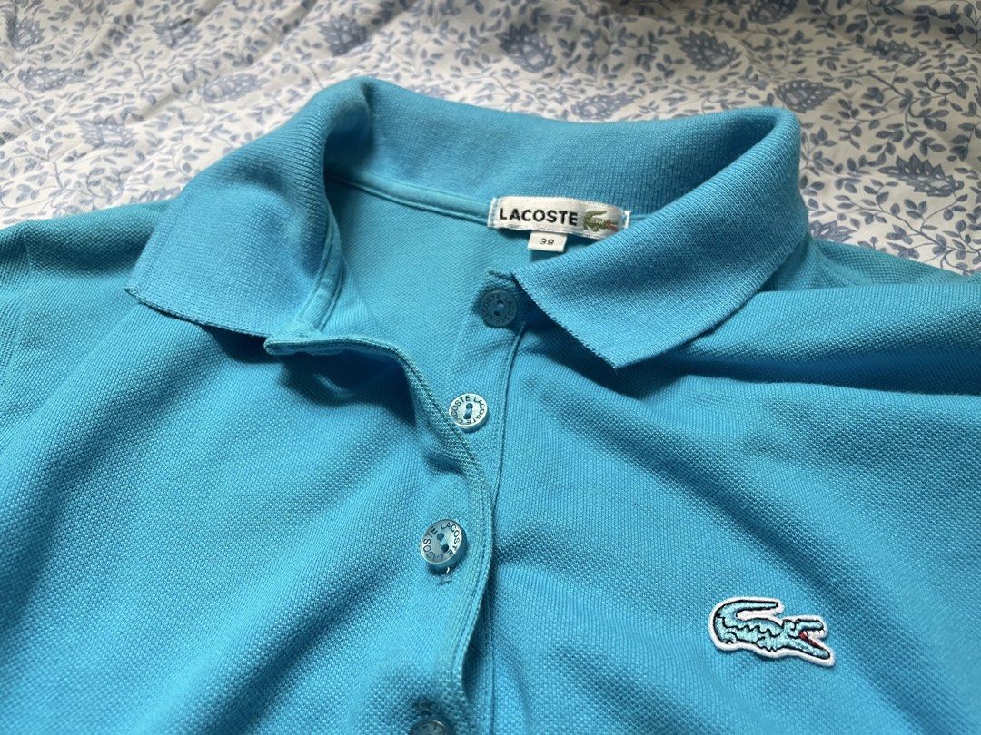 Lacoste Blue Polo Shirt Size 38 (Category: Shirts) located in General Trias. Submitted by lyzcollections. (Listing ID 1459905865, Image 1). Description: - Classic blue Lacoste polo shirt - Iconic crocodile logo on chest - Button-up neckline - Size 38 - Ideal for casual or sporty outfits.