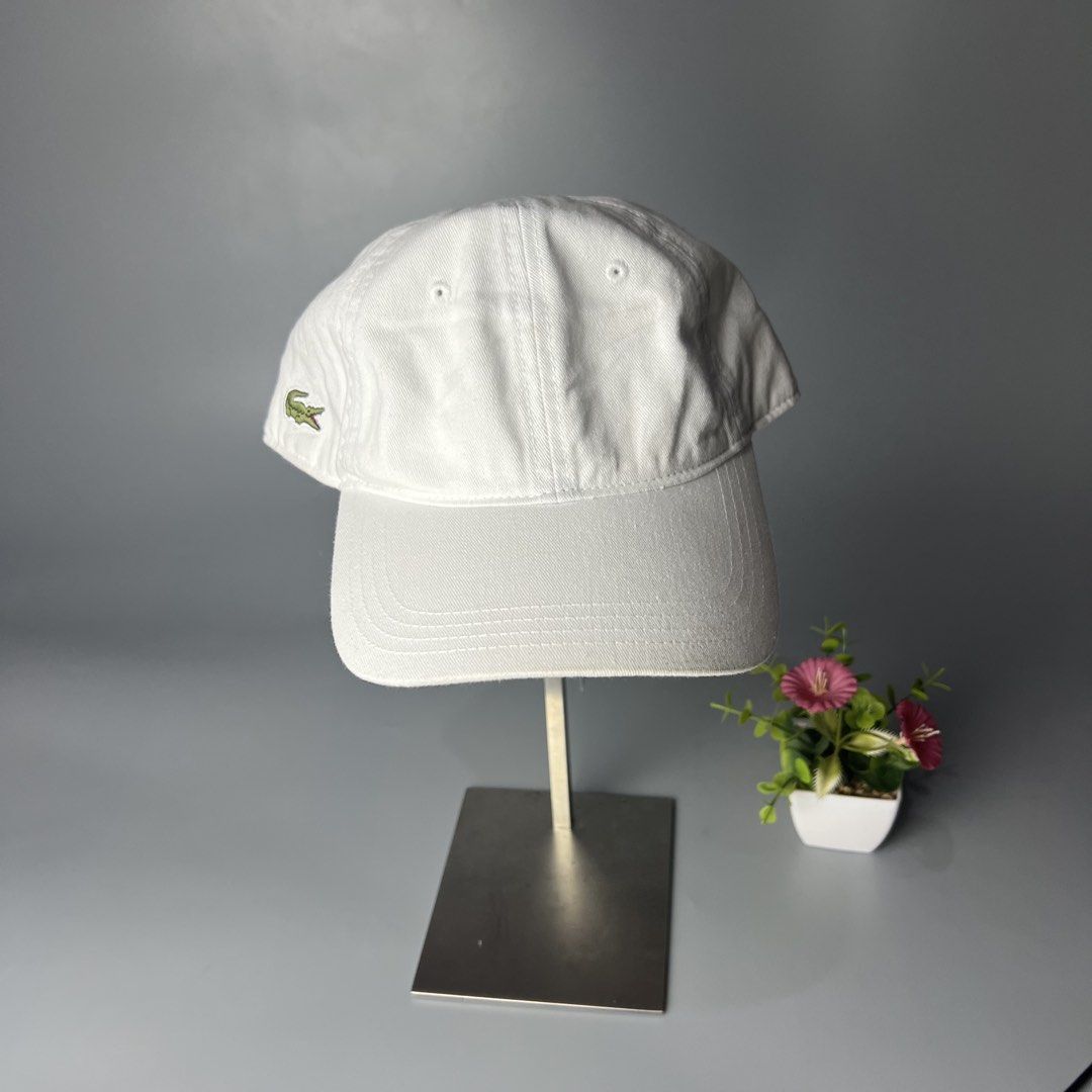 Lacoste White Baseball Cap (Category: Caps & Hats) located in Bago City. Submitted by g___shop (Listing ID 1460034216, Image 1). Description: - Classic white Lacoste cap - Iconic crocodile logo embroidered on the side - Adjustable strap at the back for a comfortable fit - Simple and versatile design - Ideal for everyday wear.