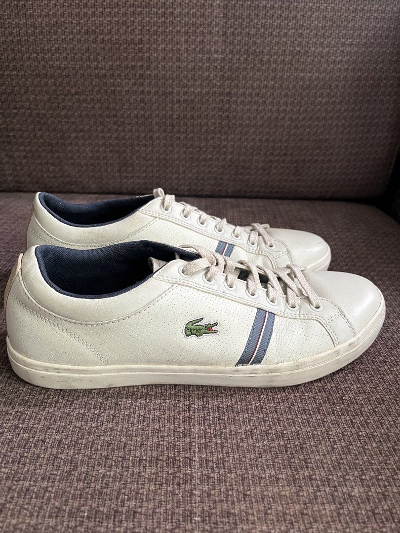 Lacoste White Leather Sneakers with Blue Stripes (Category: Casual Shoes) located in Manila. Submitted by lowkeyxan (Listing ID 1459986136, Image 3). Description: Original White leather Lacoste sneakers. Features the iconic crocodile logo on the side. Has a navy blue inner lining and subtle blue stripes on the side. Laces are white. Good for casual wear..