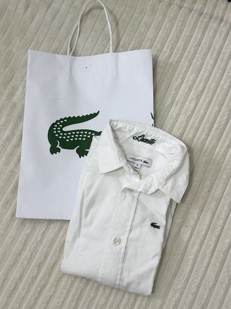 Lacoste White Long Sleeve Shirt Size 4 (Category: Tshirts & Polo Shirts ) located in Urdaneta. Submitted by hellocity16 (Listing ID 1459978705, Image 1). Description: - Authentic Lacoste white long sleeve shirt - Size: 4 - Iconic embroidered crocodile logo on chest - Classic button-up front with collar - Comes with original Lacoste paper bag.