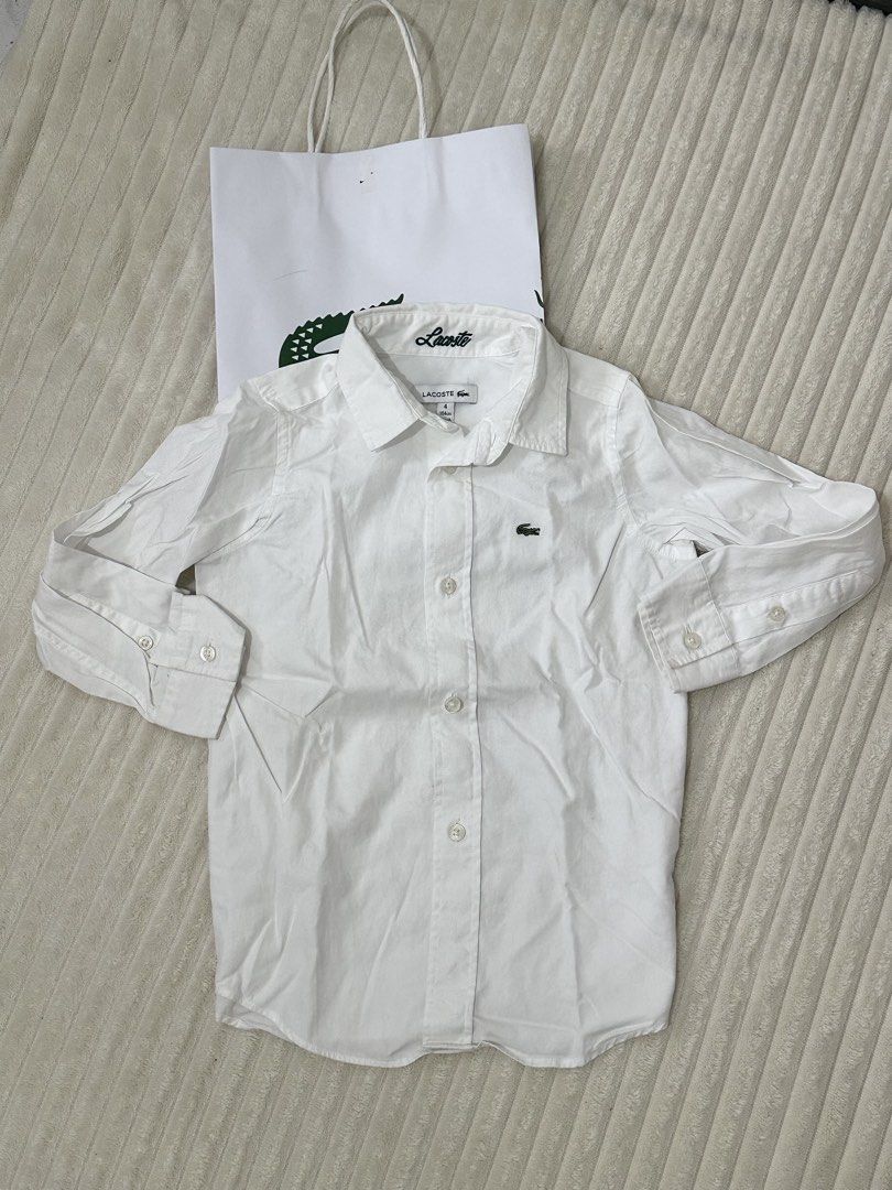Lacoste White Long Sleeve Shirt Size 4 (Category: Tshirts & Polo Shirts ) located in Urdaneta. Submitted by hellocity16 (Listing ID 1459978705, Image 2). Description: - Authentic Lacoste white long sleeve shirt - Size: 4 - Iconic embroidered crocodile logo on chest - Classic button-up front with collar - Comes with original Lacoste paper bag.