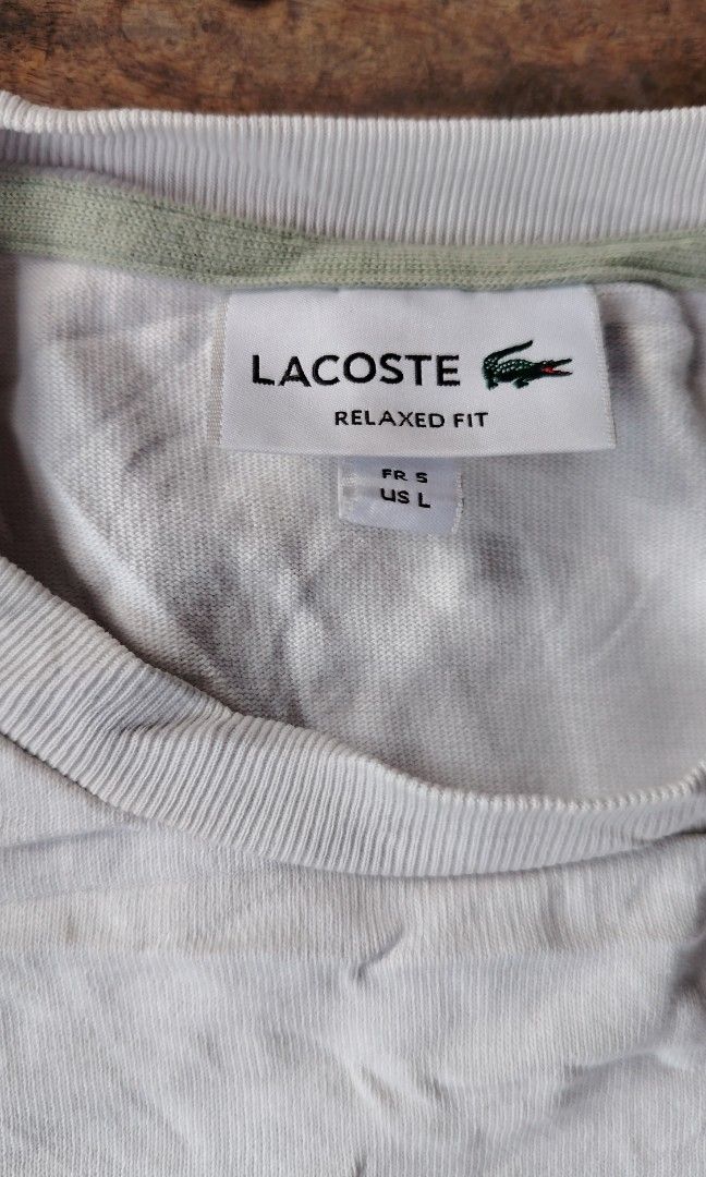 Lacoste white shirt (Category: Tshirts & Polo Shirts ) located in Cagayan de Oro. Submitted by johnzj002 (Listing ID 1460054706, Image 2). Description: Size L Issue need wash galing pa bulto Dimes 21x27.