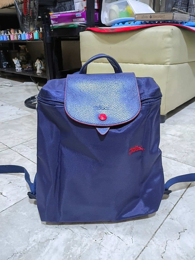 LC Nylon Backpack (Category: Backpacks) located in Cavite. Submitted by ms.de.clutter (Listing ID 1460054403, Image 1). Description: - Navy blue nylon backpack - Red embroidered Polo logo on front - Textured faux leather flap with red button snap closure - Zipper closure for main compartment - Adjustable shoulder straps - Ideal for everyday use or travel.