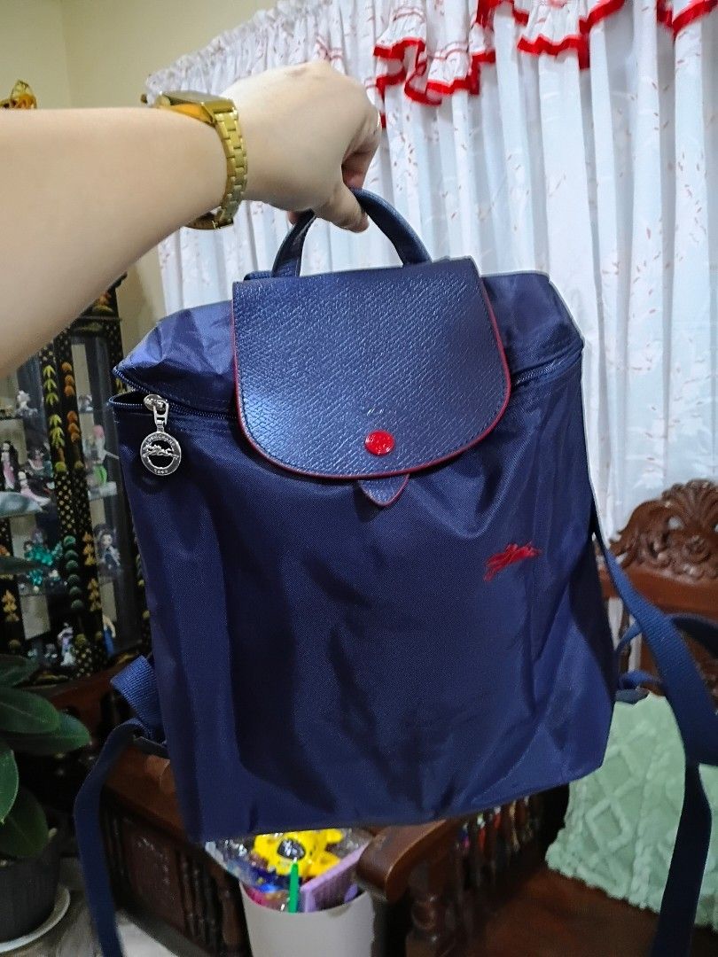 LC Nylon Backpack (Category: Backpacks) located in Cavite. Submitted by ms.de.clutter (Listing ID 1460054403, Image 2). Description: - Navy blue nylon backpack - Red embroidered Polo logo on front - Textured faux leather flap with red button snap closure - Zipper closure for main compartment - Adjustable shoulder straps - Ideal for everyday use or travel.
