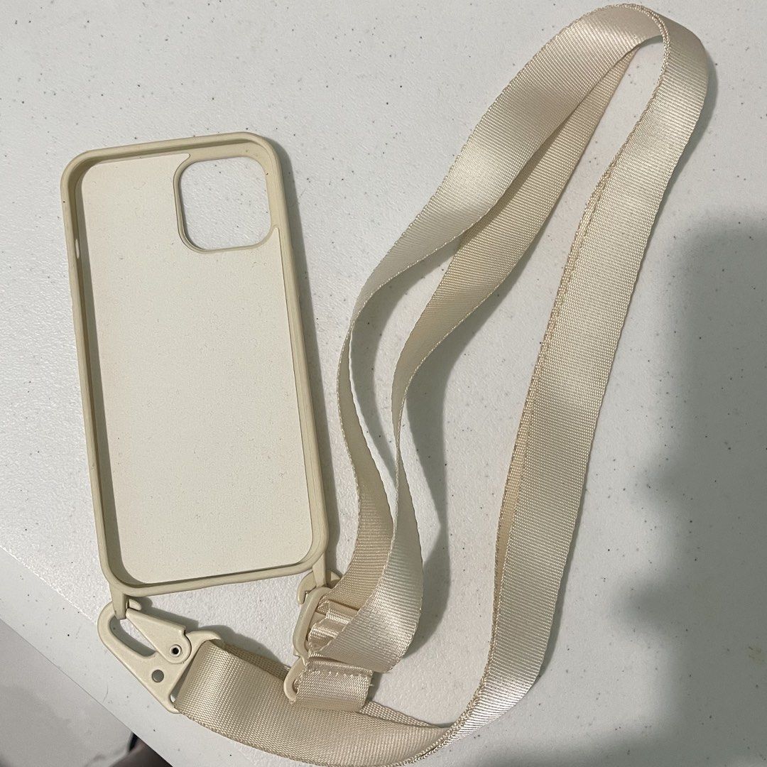 Light Beige Lanyard Case for iPhone 12 Pro Max (Category: Cases & Sleeves) located in Subic. Submitted by pepaydeclutters (Listing ID 1460094764, Image 2). Description: Used once then left in storage No stains/defects Comes with adjustable and removable strap (up to 150cm in length) Sturdy hardware! Perfect for clerkship/internship/travelling.