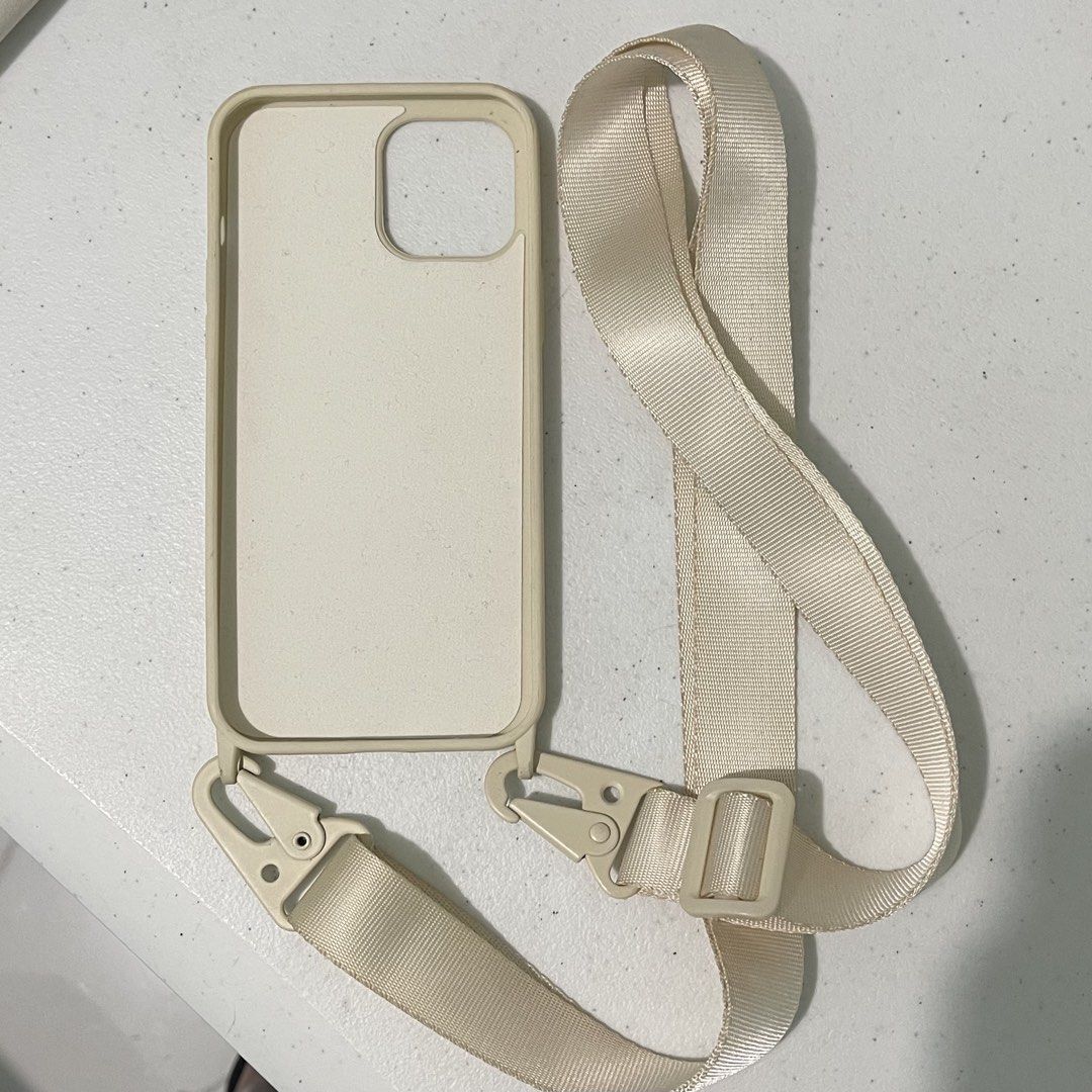 Light Beige Lanyard Case for iPhone 12 Pro Max (Category: Cases & Sleeves) located in Subic. Submitted by pepaydeclutters (Listing ID 1460094764, Image 1). Description: Used once then left in storage No stains/defects Comes with adjustable and removable strap (up to 150cm in length) Sturdy hardware! Perfect for clerkship/internship/travelling.