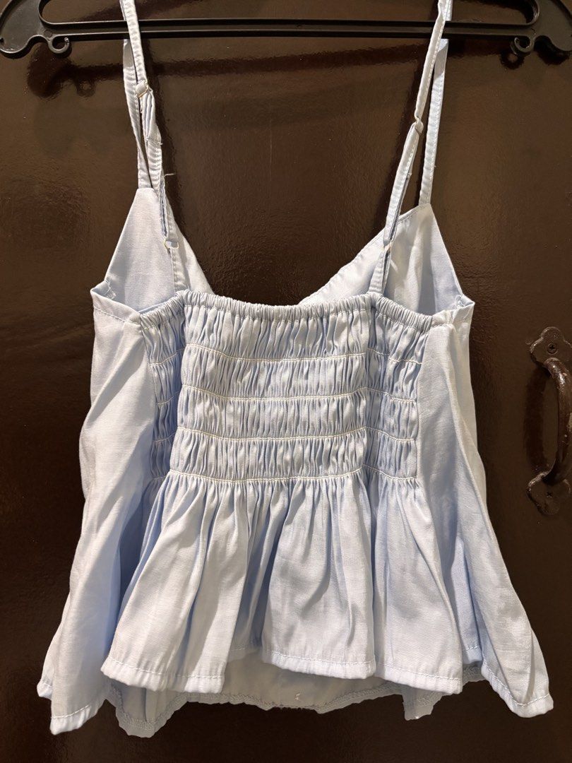 Light Blue Smocked Back Camisole Top (Category: Sleeveless) located in Valenzuela. Submitted by chamenamena (Listing ID 1459969468, Image 2). Description: - Cute light blue camisole top - Button front detail - Adjustable straps - Smocked back for a comfy fit - Peplum hem .