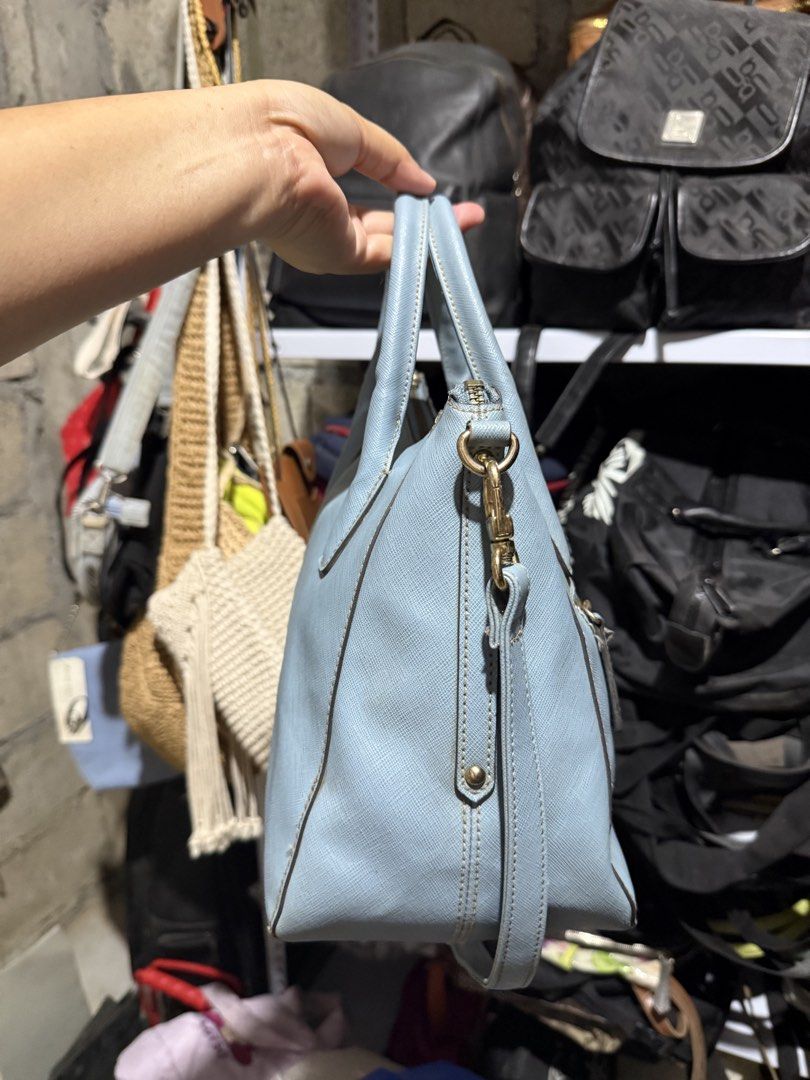 Light Blue Textured Handbag with Shoulder Strap (Category: Shoulder Bags) located in Mainit. Submitted by cherpaulassortedshop (Listing ID 1460029052, Image 2). Description: - Light blue textured handbag - Zip closure on top - Back zip pocket for extra storage - Detachable shoulder strap for versatility - Elegant gold hardware details - Clean and well-maintained interior - Ideal everyday bag Ukay ukay source.