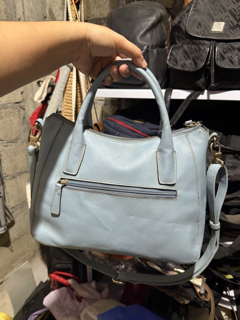 Light Blue Textured Handbag with Shoulder Strap (Category: Shoulder Bags) located in Mainit. Submitted by cherpaulassortedshop (Listing ID 1460029052, Image 3). Description: - Light blue textured handbag - Zip closure on top - Back zip pocket for extra storage - Detachable shoulder strap for versatility - Elegant gold hardware details - Clean and well-maintained interior - Ideal everyday bag Ukay ukay source.
