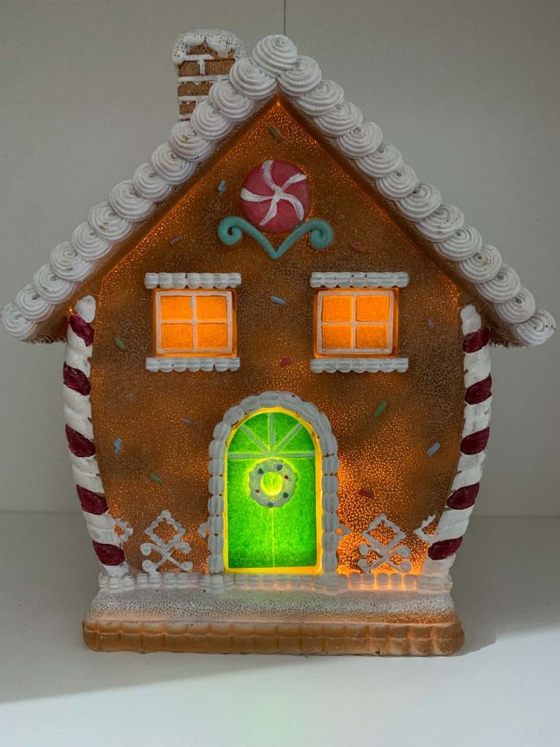 Light-Up Gingerbread House Christmas Decoration (Category: Other Home Decor) located in Quezon City. Submitted by dfabloveverything (Listing ID 1460027409, Image 1). Description: - Adorable gingerbread house decoration - Features warm orange glowing windows - Bright green door detail - Ideal for festive home displays - Creates a cozy holiday ambiance - Perfect for mantelpieces or shelves - Like New - No Box - Battery Operated.
