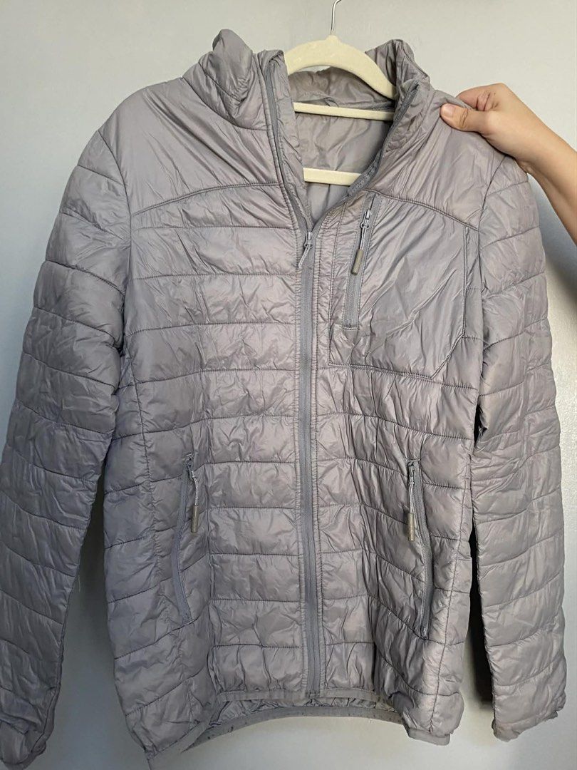 Lightweight Grey Puffer Jacket (Category: Coats, Jackets and Outerwear) located in Manila. Submitted by Mimi020623 (Listing ID 1460018268, Image 1). Description: - Grey puffer jacket - Full front zipper closure - Two zippered side pockets - One zippered chest pocket - Lightweight and warm material - Ideal for layering.