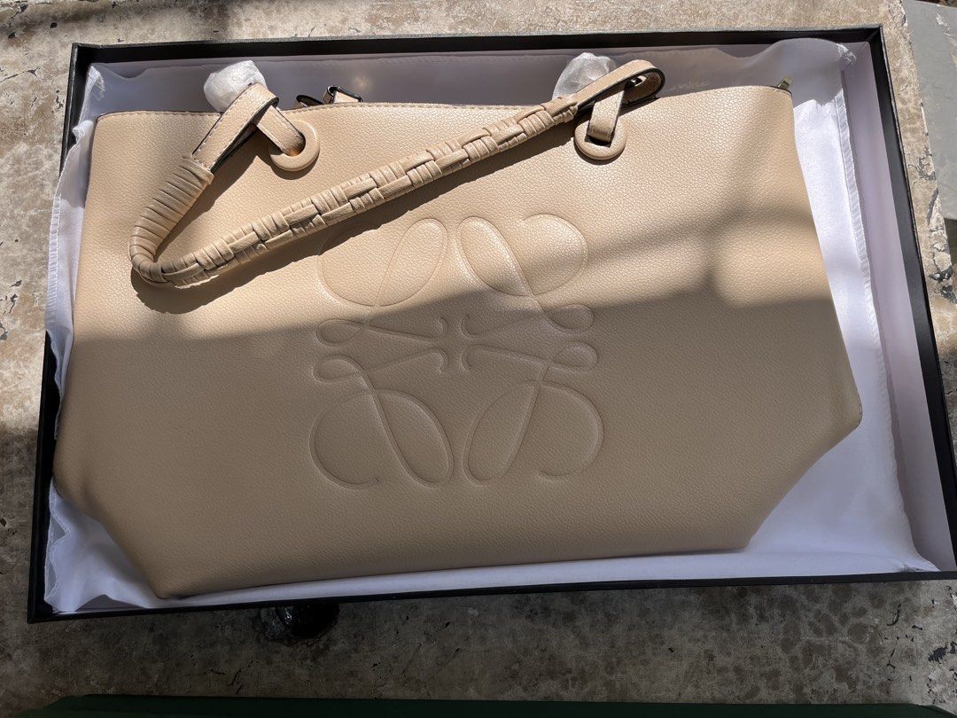 LOEWE Anagram Tote Bag Beige Leather (Category: Luxury Bags & Wallets) located in Midsayap. Submitted by brandedloves1031 (Listing ID 1460012659, Image 2). Description: - Authentic LOEWE tote bag - Color: Beige - Material: Leather - Iconic Anagram logo embossed - Braided handle detail - Includes original box - Ideal for everyday use.