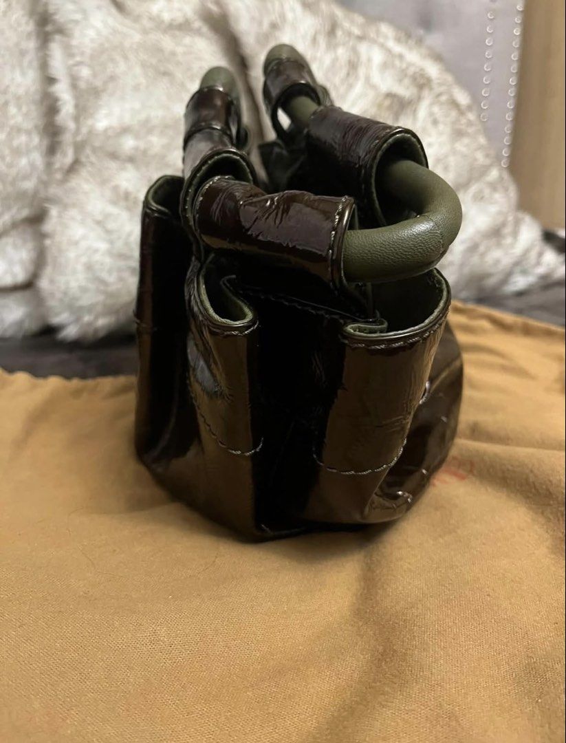 Loewe Patent Leather Handbag (Category: Luxury Bags & Wallets) located in Manila. Submitted by chantalsalonga (Listing ID 1460089788, Image 3). Description: - Authentic Loewe brown patent leather handbag - Features iconic embossed Anagram logo on the front - Unique and stylish green handle detail - Comes with original Loewe dust bag - A versatile and fashionable accessory.
