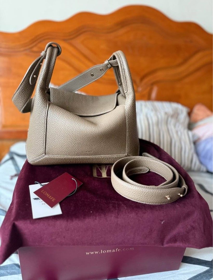 LOMAFE Pebble Grain Leather Handbag with Strap (Category: Shoulder Bags) located in Manila. Submitted by deanne.027 (Listing ID 1459910772, Image 1). Description: - Chic taupe pebble grain leather handbag - Versatile with a detachable shoulder strap - Elegant gold hardware details, including bottom studs - Comes with original dust bag and box - Brand new, with tag still attached.