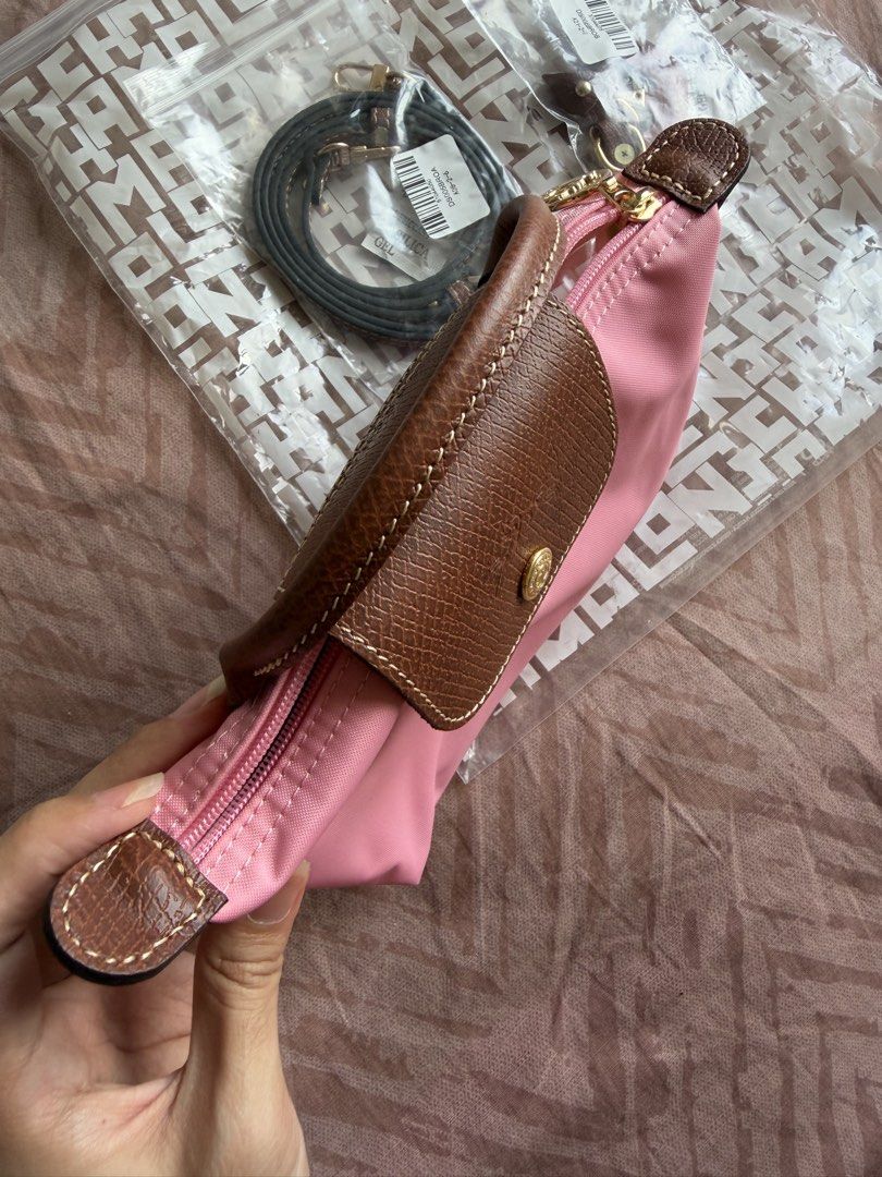 Longchamp Le Pliage Mini Pouch with Strap Pink (Category: Purses & Pouches) located in Manila. Submitted by shopelainevillapando (Listing ID 1459975048, Image 3). Description: - Authentic Pink Longchamp Pouch - Got it for USD120 - Includes original packaging - Detachable strap for versatility - Features leather trim and gold hardware - Tag still attached - Ideal for organizing essentials or as a small crossbody bag.