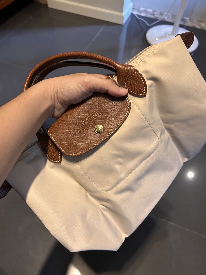 Longchamp Le Pliage Top Handle Bag Beige (Category: Luxury Bags & Wallets) located in Quezon City. Submitted by jaypee.abergas (Listing ID 1460046028, Image 1). Description: - Authentic beige Longchamp Le Pliage Cuir small top handle bag - Genuine leather trim and handles Used twice only Close to new condition Dm.