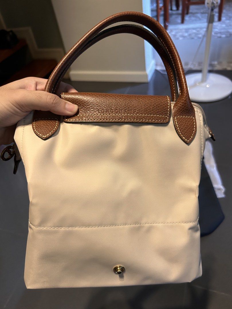 Longchamp Le Pliage Top Handle Bag Beige (Category: Luxury Bags & Wallets) located in Quezon City. Submitted by jaypee.abergas (Listing ID 1460046028, Image 2). Description: - Authentic beige Longchamp Le Pliage Cuir small top handle bag - Genuine leather trim and handles Used twice only Close to new condition Dm.