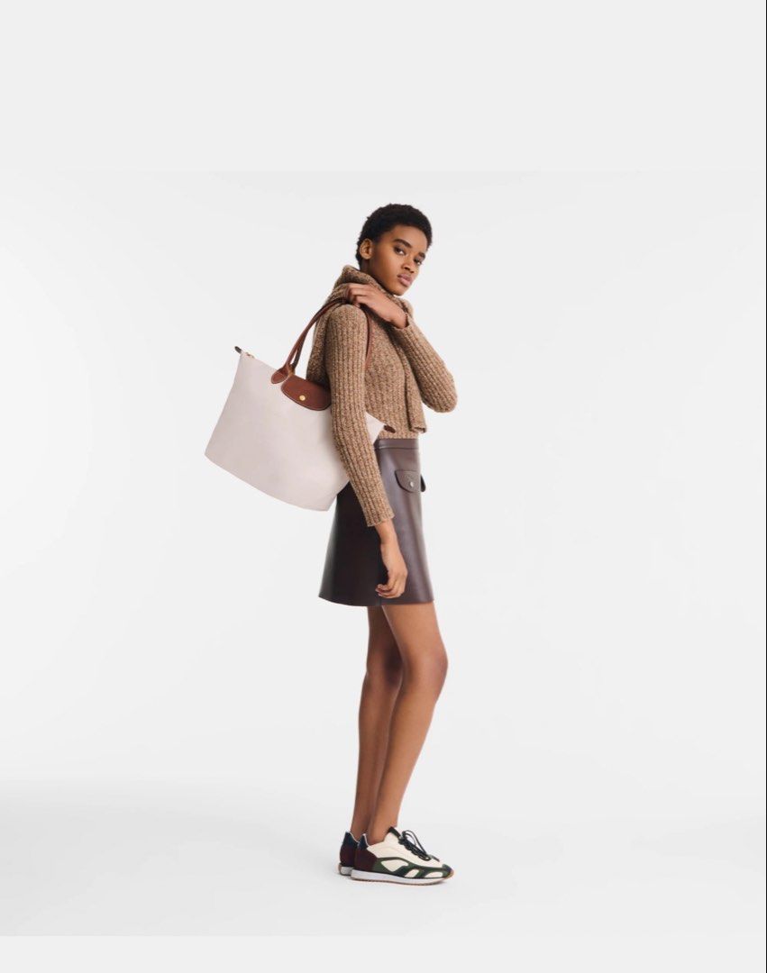 Longchamp Le Pliage Tote Bag Paper Large (Category: Luxury Bags & Wallets) located in San Fernando. Submitted by marynicole2911 (Listing ID 1459976198, Image 2). Description: - Classic Authentic Longchamp tote bag - Beige nylon with brown leather handles and trim - Folds flat for easy storage - Zippered top closure - Front snap closure pocket - Ideal for everyday use - Roomy interior.