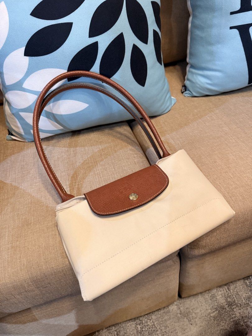 Longchamp Le Pliage Tote Bag Paper Large (Category: Luxury Bags & Wallets) located in San Fernando. Submitted by marynicole2911 (Listing ID 1459976198, Image 3). Description: - Classic Authentic Longchamp tote bag - Beige nylon with brown leather handles and trim - Folds flat for easy storage - Zippered top closure - Front snap closure pocket - Ideal for everyday use - Roomy interior.