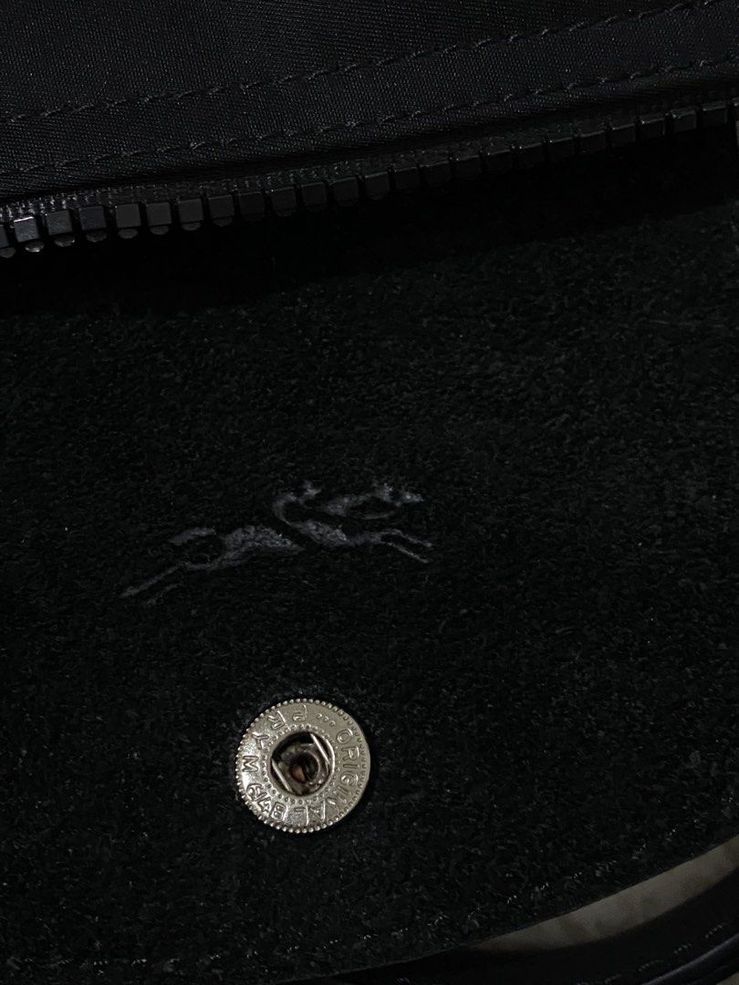 Longchamp Paris Nylon Top Handle Bag (Category: Luxury Bags & Wallets) located in Quezon City. Submitted by irldn_ (Listing ID 1459925743, Image 3). Description: - Longchamp black nylon handbag - Made in France - Versatile: Top handles and detachable shoulder strap - Secure closure: Zipper with leather trim and snap button flap - Interior detail: Small embossed horse logo.