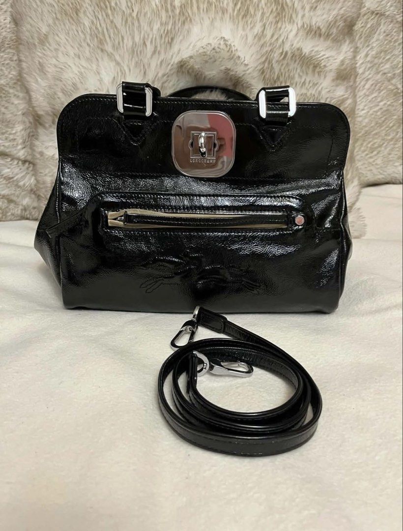 Longchamp Patent Leather Top Handle Bag with Strap (Category: Luxury Bags & Wallets) located in Manila. Submitted by chantalsalonga (Listing ID 1460090310, Image 1). Description: - Genuine Longchamp patent leather handbag - Available in classic Black or vibrant Deep Red/Orange - Features a comfortable top handle - Includes a detachable shoulder strap for versatility - Convenient front zip pocket for quick access - Secure clasp closure to keep you