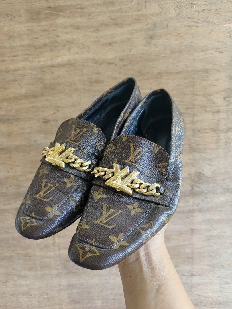 Louis Vuitton Monogram Chain Loafers (Category: Loafers) located in Davao. Submitted by vndrgd (Listing ID 1459999367, Image 1). Description: - Classic Louis Vuitton monogram loafers - Iconic LV logo with gold chain detail - Slip-on style - Made in Italy - A stylish addition to any outfit.