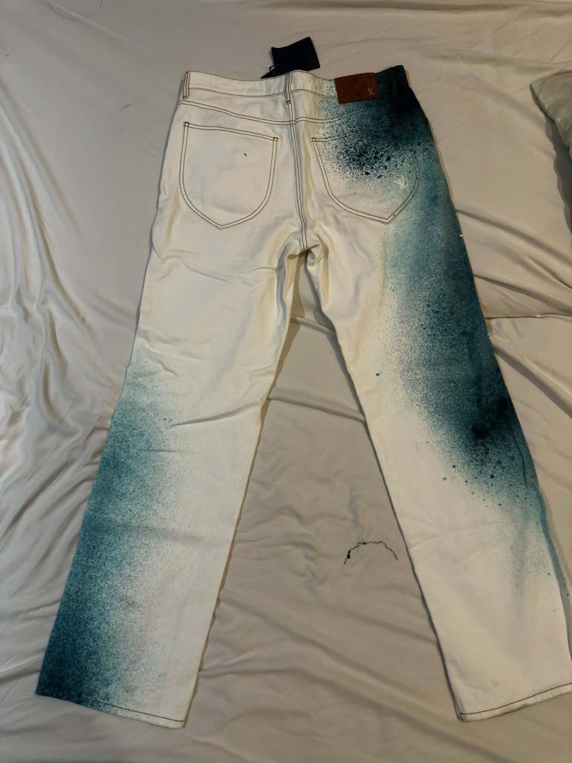 Louis Vuitton Spray Paint Jeans (Category: Jeans) located in Manila. Submitted by zxcvbnm_100 (Listing ID 1460090471, Image 1). Description: - Brand new white denim jeans - Unique teal spray paint effect - Classic five-pocket style - Leather logo patch on back - Some paint splatter on front and back legs - Tag still attached.