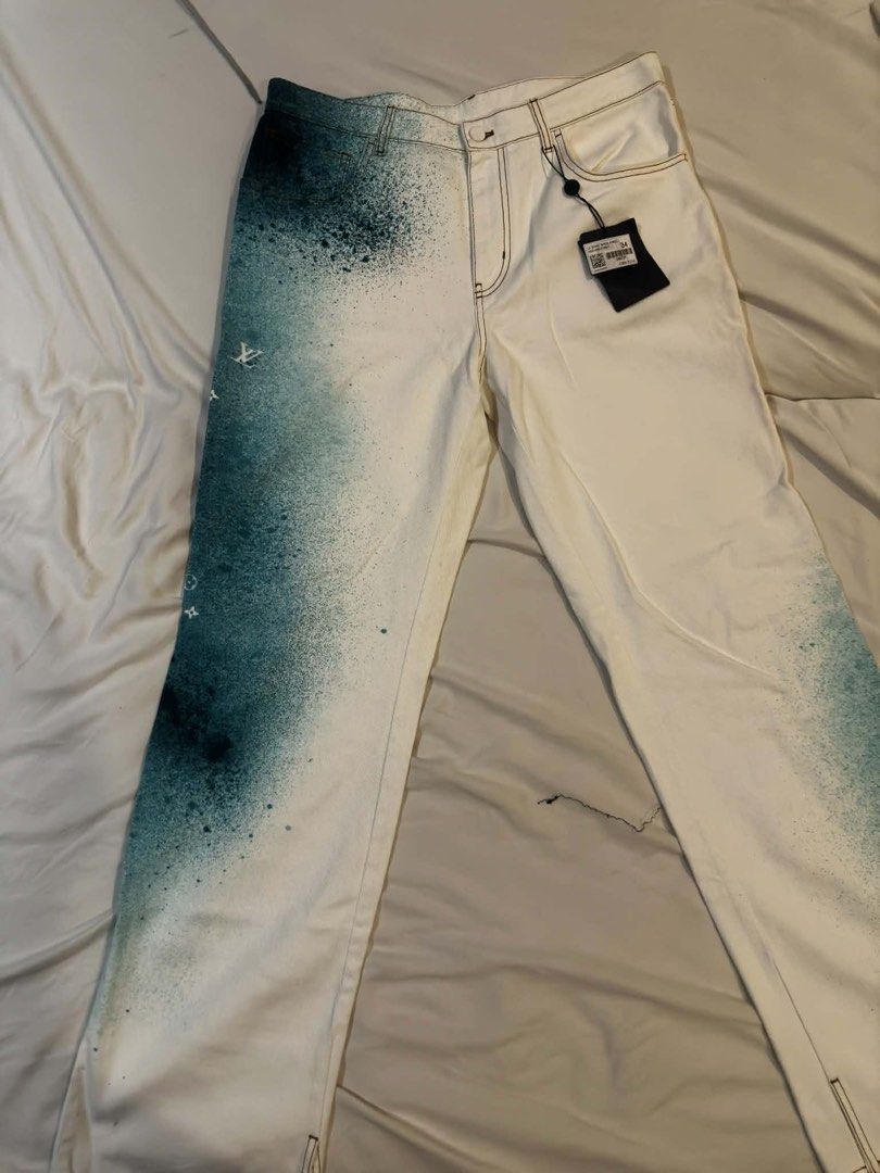 Louis Vuitton Spray Paint Jeans (Category: Jeans) located in Manila. Submitted by zxcvbnm_100 (Listing ID 1460090471, Image 2). Description: - Brand new white denim jeans - Unique teal spray paint effect - Classic five-pocket style - Leather logo patch on back - Some paint splatter on front and back legs - Tag still attached.