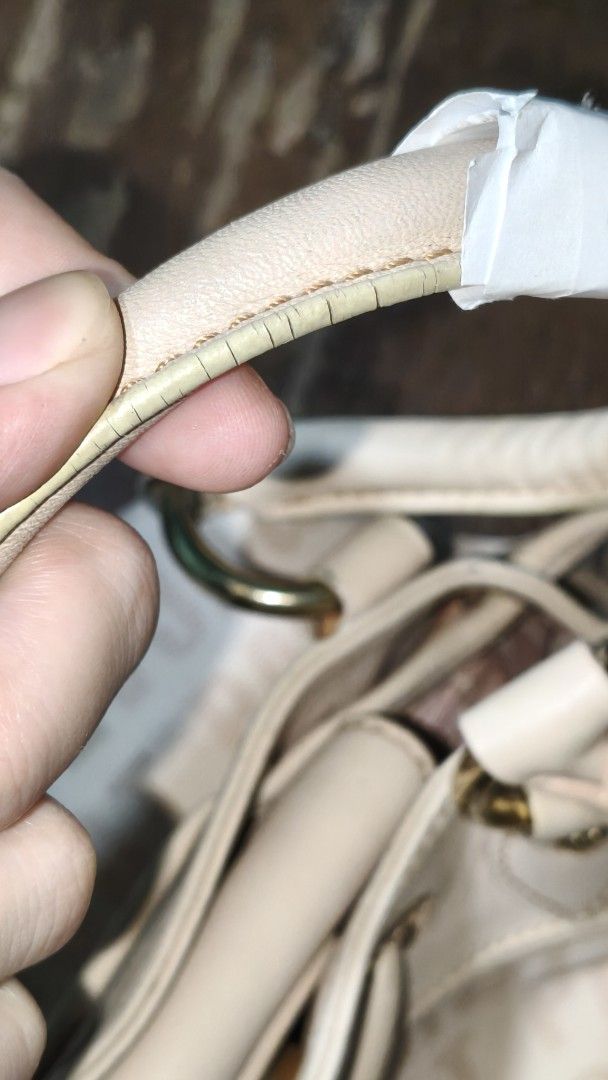 Lovcat Paris bag (Category: Luxury Bags & Wallets) located in Quezon City. Submitted by morningstar_52 (Listing ID 1460084869, Image 3). Description: - Lovcat Paris cream canvas handbag - Signature logo pattern with leather trim - Gold hardware with cute heart charm and tassels - Interior zip pocket and slip pockets - Minor wear on handle edges and scuffs on heart charm - Still a stylish and functional bag.