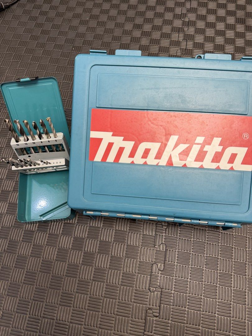Makita Hammer Drill NHP1300S with Drill Bits and Case (Category: Construction Tools & Equipment) located in Manila. Submitted by mommyzel (Listing ID 1459970568, Image 1). Description: - Makita NHP1300S Hammer Drill - Powerful 430W motor - Variable speed: 0-2700 RPM - Comes with a set of drill bits - Includes original case for storage - Auxiliary handle for better control - Ideal for various drilling applications.
