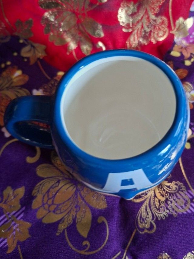 Marvel Gurihiro Captain America 3D Mug (Category: Coffee & Tea Tableware) located in Consolacion. Submitted by luxekerei (Listing ID 1456830016, Image 2). Description: - is a Marvel x Gurihiru Captain America face ceramic mug featuring his signature blue cowl and white "A" emblem.