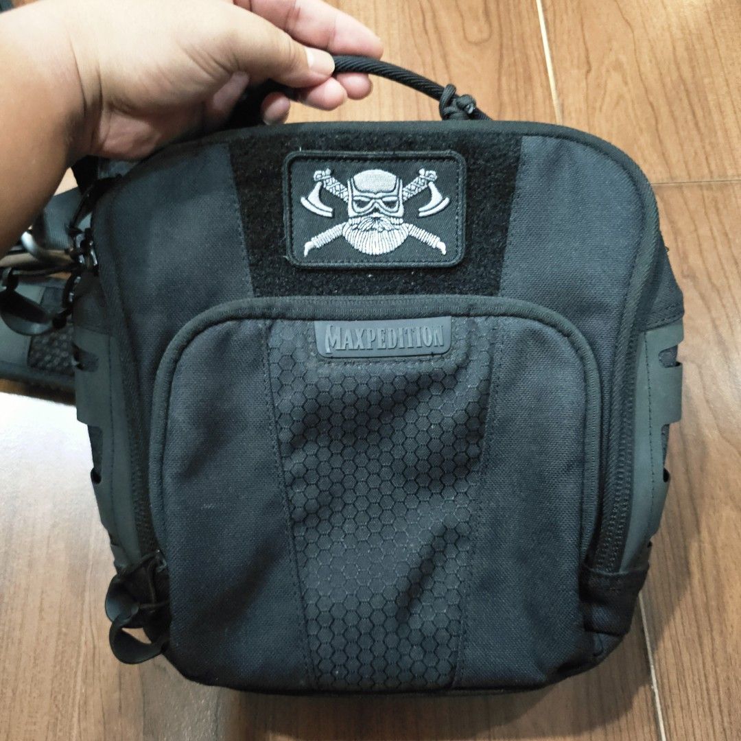 Maxpedition Lochspyr Black Sling Bag with Skull Patch (Category: Sling Bags) located in Quezon City. Submitted by northernlegends (Listing ID 1459943140, Image 2). Description: - Maxpedition black sling bag - Features a cool skull patch on the front - Multiple zippered compartments for organization - Padded mesh back for comfort - Adjustable strap with buckle closure - Ideal for everyday carry or travel.