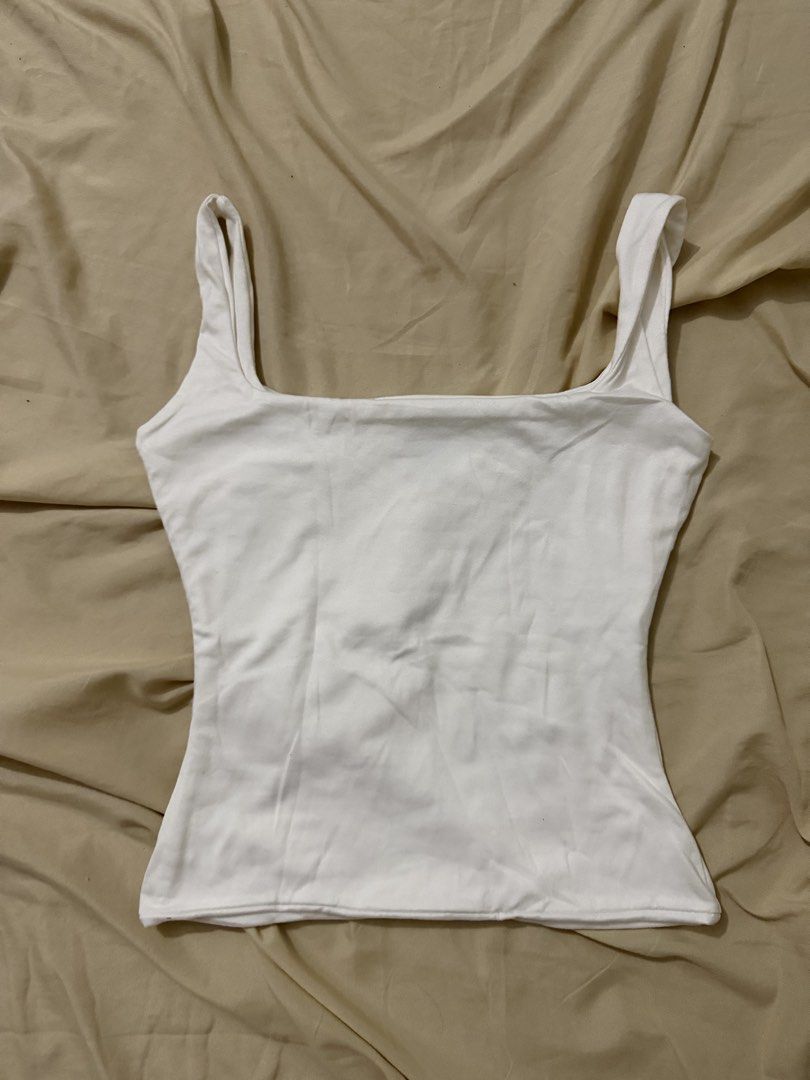 MERA White Square Neck Tank Top Size S (Category: Sleeveless) located in Cavite. Submitted by christianneeee (Listing ID 1460020001, Image 1). Description: - MERA white tank top - Square neckline with thick straps - Soft and comfortable fabric - Perfect for layering or wearing solo - A versatile essential for any wardrobe.