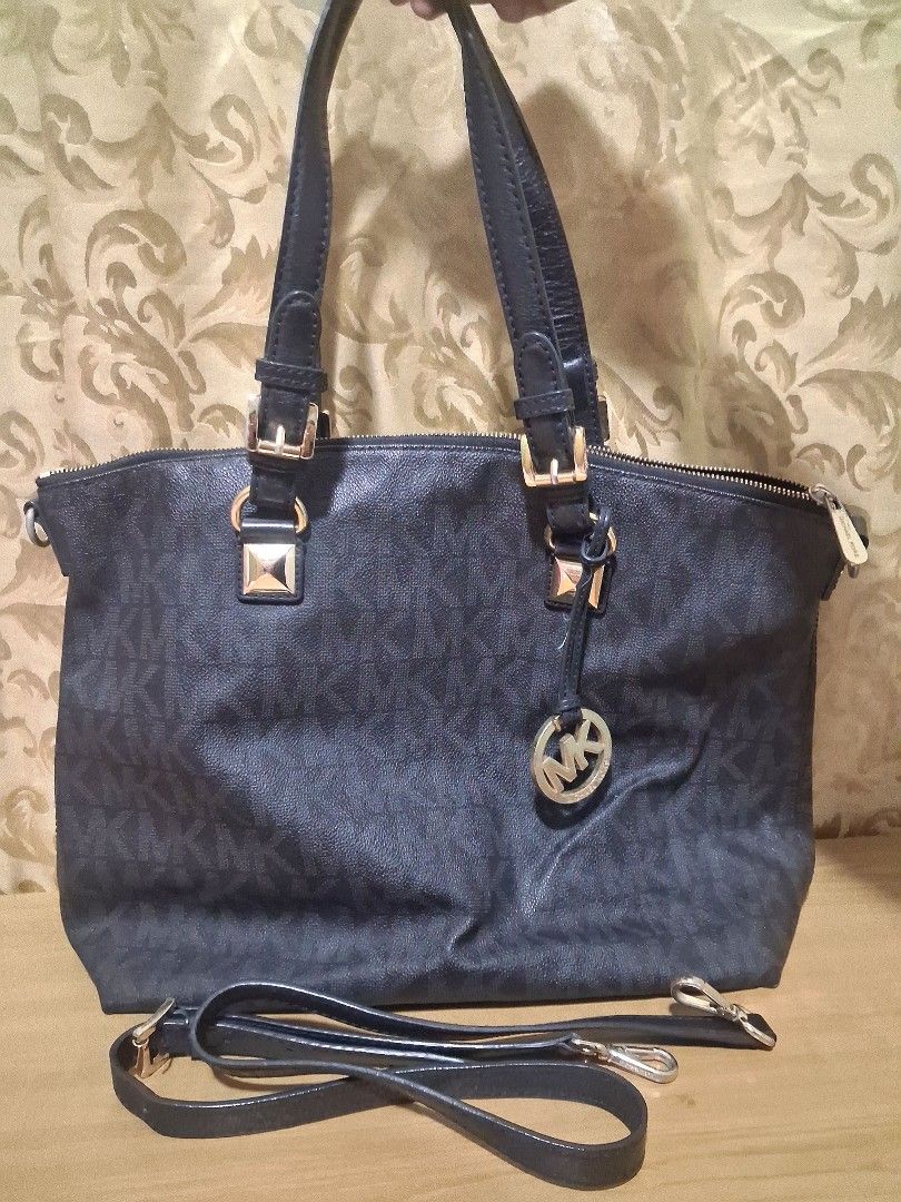 Authentic Michael Kors Bag / Michael Kors black shoulder bag (Category: Luxury Bags & Wallets) located in Bocaue. Submitted by yanicas_shop (Listing ID 1460056218, Image 1). Description: - Authentic Michael Kors bag in black. - Features the signature all-over MK monogram print. - Elegant gold hardware details. - Comes with a detachable shoulder strap for versatile carrying. - comes with dust bag -Michael Kors Bag with Shoulder Strap - light flaw 