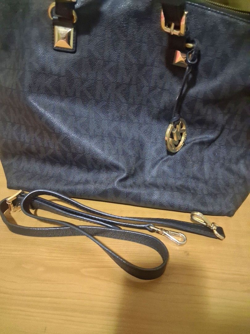 Authentic Michael Kors Bag / Michael Kors black shoulder bag (Category: Luxury Bags & Wallets) located in Bocaue. Submitted by yanicas_shop (Listing ID 1460056218, Image 2). Description: - Authentic Michael Kors bag in black. - Features the signature all-over MK monogram print. - Elegant gold hardware details. - Comes with a detachable shoulder strap for versatile carrying. - comes with dust bag -Michael Kors Bag with Shoulder Strap - light flaw 