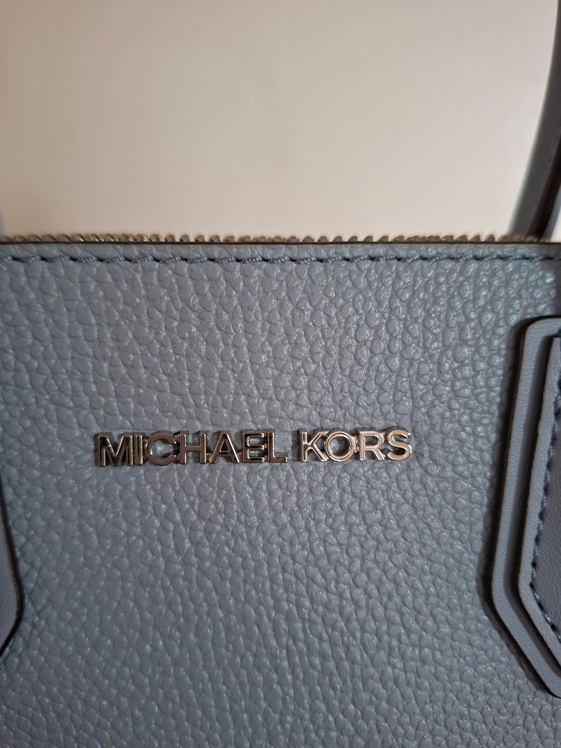Michael Kors Leather Handbag (Category: Luxury Bags & Wallets) located in Navotas City. Submitted by joy08jopio (Listing ID 1459930456, Image 2). Description: - Light blue pebbled leather handbag - Authentic Michael Kors with logo detail - Features top handles and a detachable shoulder strap - Secure zipper closure - Includes care card - Ideal for everyday wear.