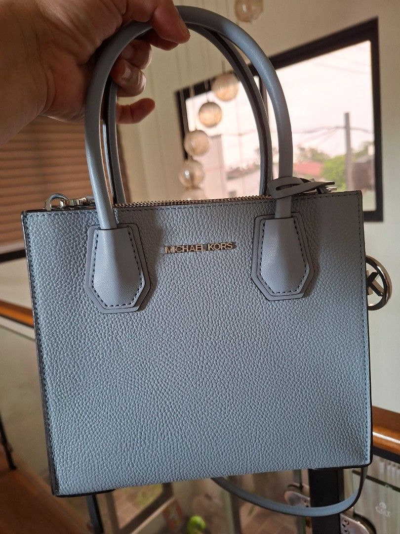 Michael Kors Leather Handbag (Category: Luxury Bags & Wallets) located in Navotas City. Submitted by joy08jopio (Listing ID 1459930456, Image 1). Description: - Light blue pebbled leather handbag - Authentic Michael Kors with logo detail - Features top handles and a detachable shoulder strap - Secure zipper closure - Includes care card - Ideal for everyday wear.