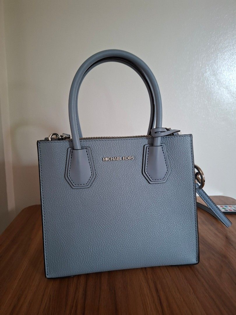Michael Kors Leather Handbag (Category: Luxury Bags & Wallets) located in Navotas City. Submitted by joy08jopio (Listing ID 1459930456, Image 3). Description: - Light blue pebbled leather handbag - Authentic Michael Kors with logo detail - Features top handles and a detachable shoulder strap - Secure zipper closure - Includes care card - Ideal for everyday wear.