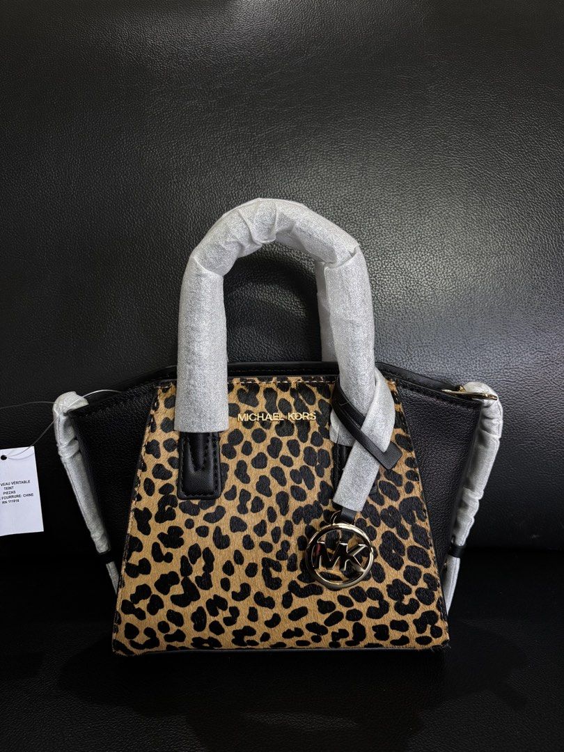 Michael Kors Leopard Print Leather Top Handle Bag (Category: Luxury Bags & Wallets) located in Manila. Submitted by chantalsalonga (Listing ID 1460090803, Image 1). Description: - Authentic Michael Kors top handle bag - Luxurious black leather body - Eye-catching leopard print front panel - Elegant gold-tone hardware - Signature MK logo charm - Comes with original tags.