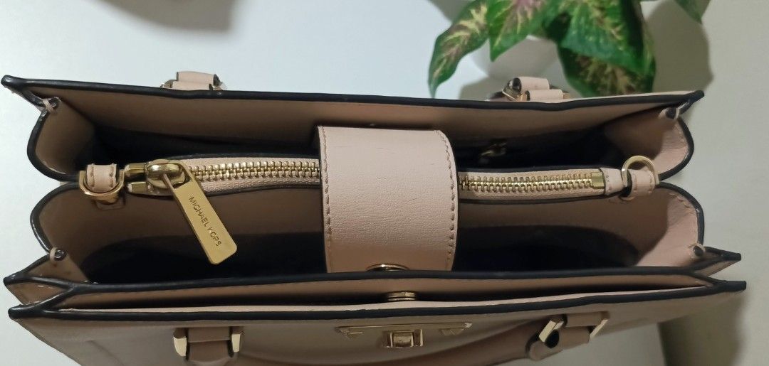 Michael Kors Pink Leather Top Handle Bag (Category: Luxury Bags & Wallets) located in Dasmarinas. Submitted by lgecarg2026 (Listing ID 1460025496, Image 2). Description: - Authentic Michael Kors handbag - Soft pink genuine leather - Elegant top handle design - Chic gold hardware accents - Secure top zipper closure - Spacious interior with multiple compartments - Perfect for daily use or special events.