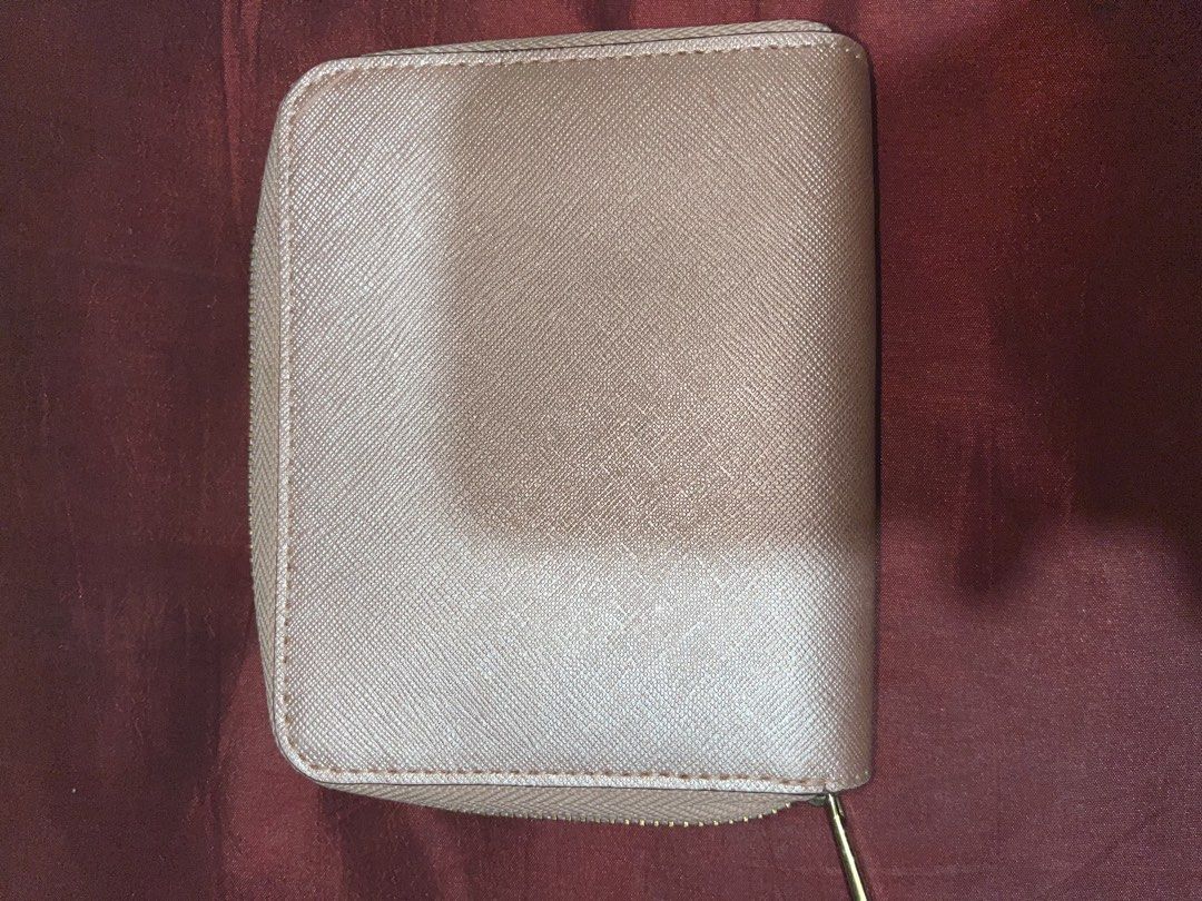 Michael Kors Rose Gold Zip Around Bifold Wallet (Category: Wallets & Card holders) located in Quezon City. Submitted by MGcollection (Listing ID 1459959950, Image 2). Description: - Michael Kors Wallet - Color: Rose Gold - Closure: Zip Around - Hardware: Gold - Interior: Ample space for cards and cash - Condition: Clean inside and out - Ideal for: Everyday use.