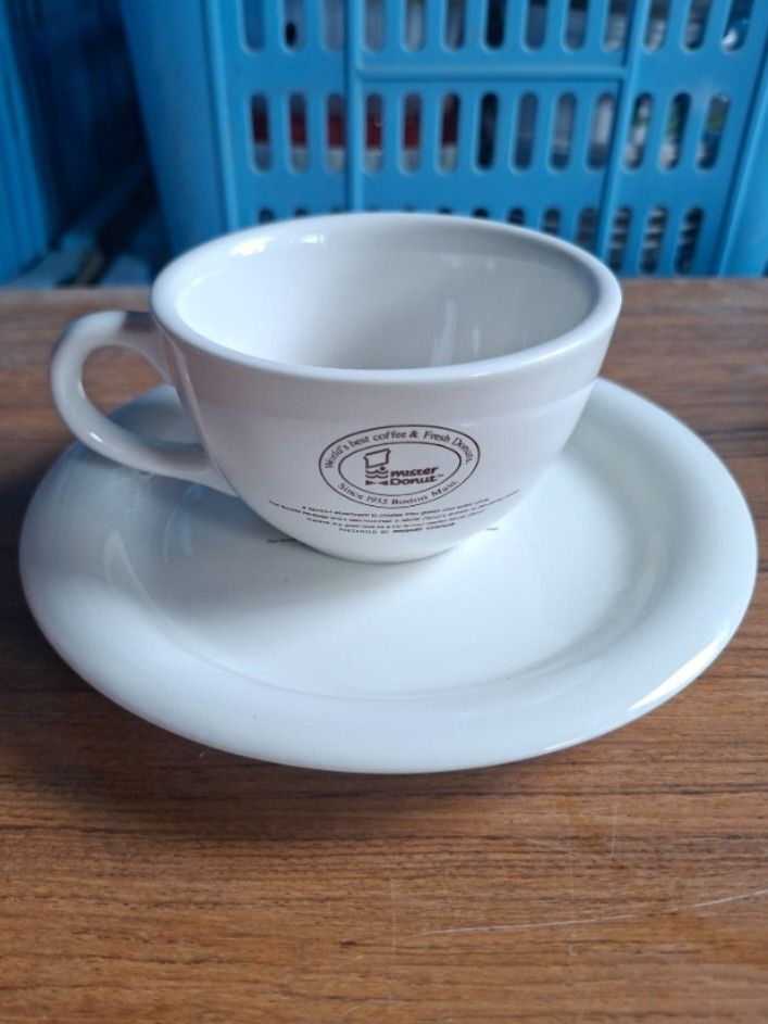 Mister Donut Cup and Saucer (Category: Coffee & Tea Tableware) located in Consolacion. Submitted by luxekerei (Listing ID 1457582793, Image 1). Description: - vintage Mister Donut ceramic coffee cup and saucer set featuring the classic "World's best coffee & Fresh Donuts Since 1955 Boston Mass." logo.