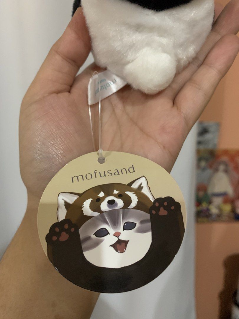 Mofusand Panda Cat Plush Keychain (Category: Plushies & Soft Toys) located in Tagaytay City. Submitted by jujujewel (Listing ID 1459903446, Image 3). Description: - Adorable Mofusand plush toy - Features a cat dressed as a panda - Includes a loop for easy attachment to bags or keys - Brand new with original tag still attached - Ideal gift for Mofusand enthusiasts and cat lovers - Soft and cuddly material.